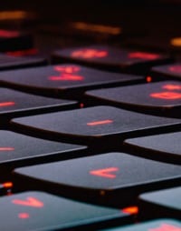 laptop keyboard with glowing red keys.